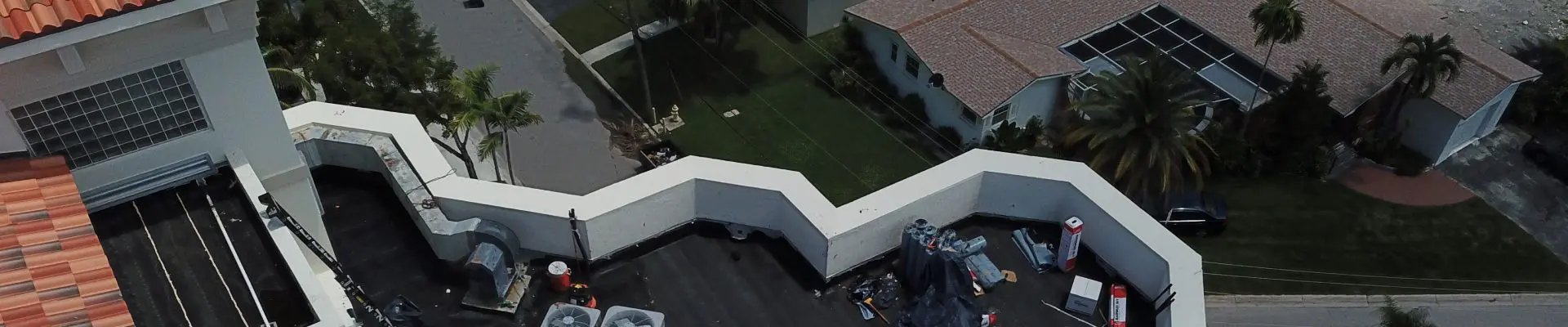 Perkins aerial photograph showing a roof terrace, parapet walls and surrounding building exterior during work.