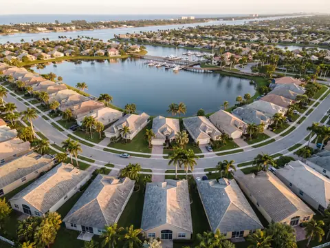 Aerial view of concrete tile roofs on homes around a lake