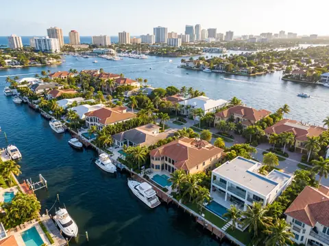 Aerial view of canal-front homes and docked boats in Fort Lauderdale