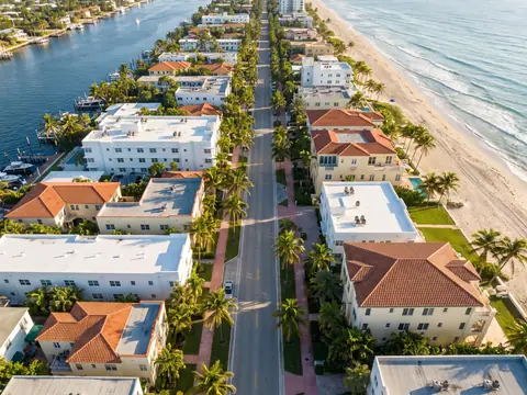 Aerial view of flat and tile roofs between the Intracoastal Waterway and the beach