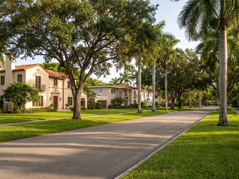 Tree-lined Miami Shores street of Mediterranean homes with barrel tile roofs