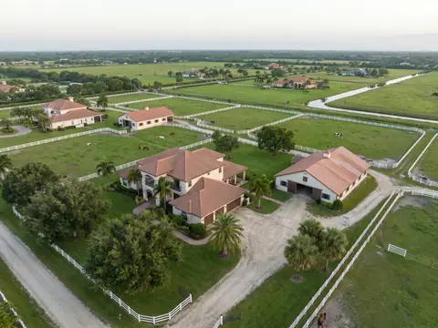 Aerial view of equestrian homes and barns with tile roofs in Wellington