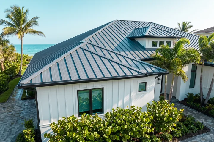 A coastal home with a slate-gray standing-seam metal roof.