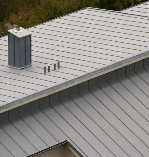 Standing-seam metal roofing with custom flashing and penetration details from the Perkins service library.