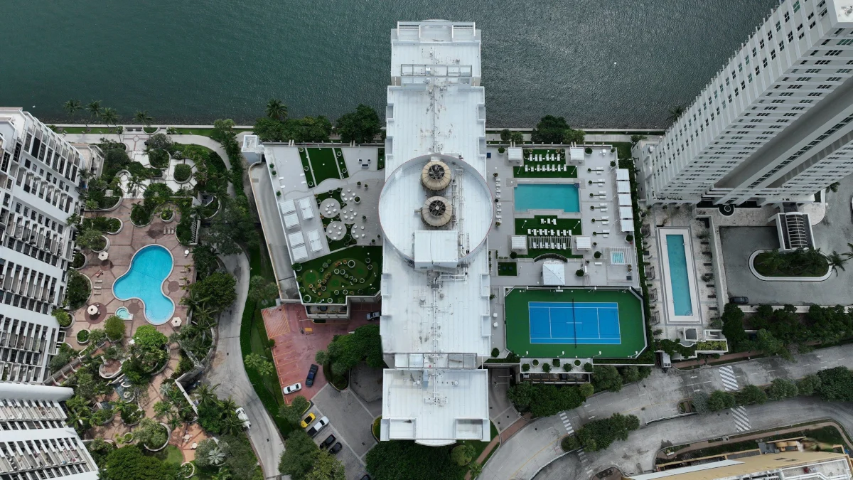 Aerial view of a commercial roof on a waterfront property in Miami-Dade